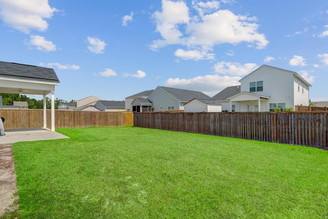 view of yard featuring a patio area and a residential view
