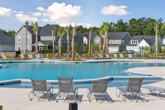 view of swimming pool featuring a jacuzzi and a patio