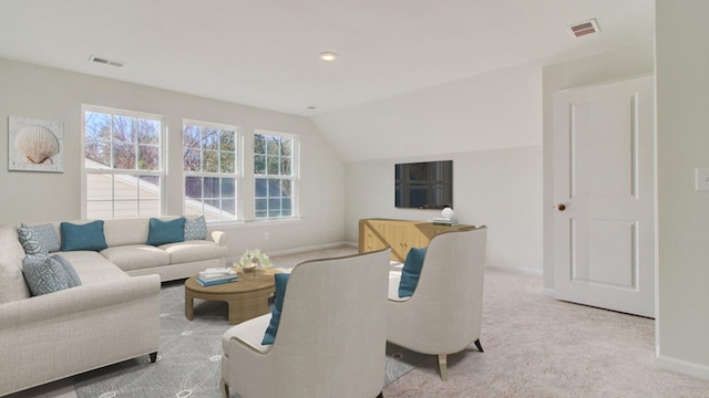 living room with light colored carpet and vaulted ceiling