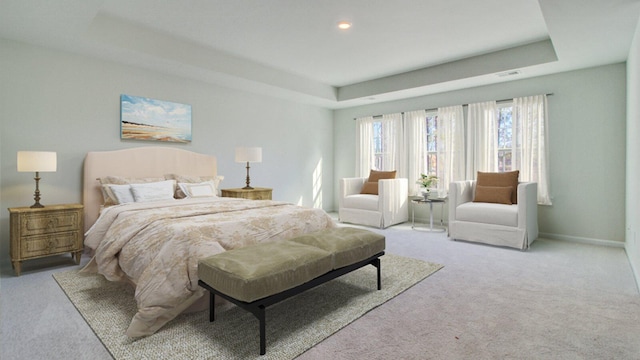 bedroom featuring a raised ceiling and light carpet