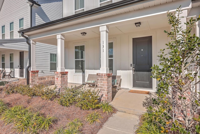 view of exterior entry with covered porch