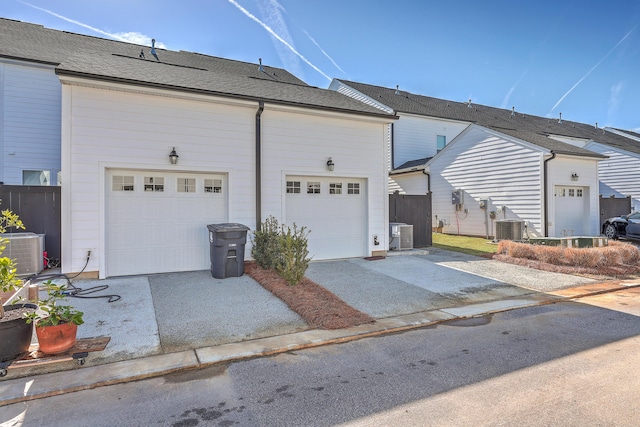 exterior space with central AC, fence, and driveway