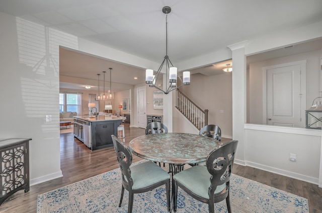 dining room with stairway, dark wood finished floors, and baseboards