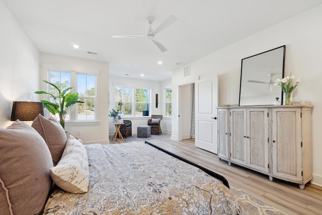 bedroom with ceiling fan and light hardwood / wood-style floors