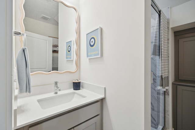 bathroom featuring vanity and an enclosed shower