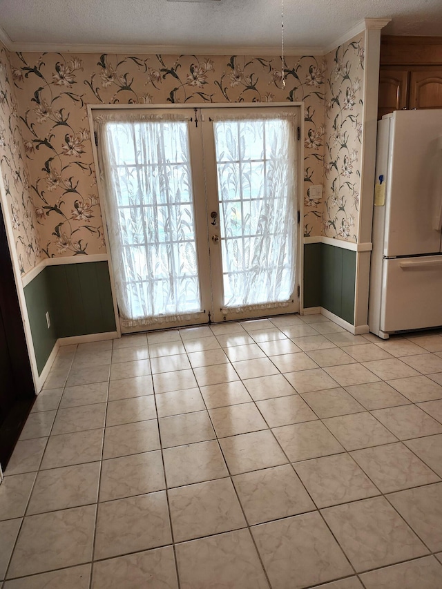 4029 Karen Dr, North Charleston, SC 29405 - unfurnished dining area with wainscoting, wallpapered walls, french doors, crown molding, and light tile patterned floors