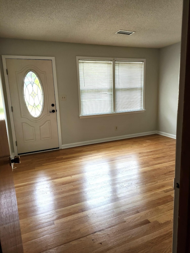 4029 Karen Dr, North Charleston, SC 29405 - foyer featuring wood finished floors, a textured ceiling, and baseboards