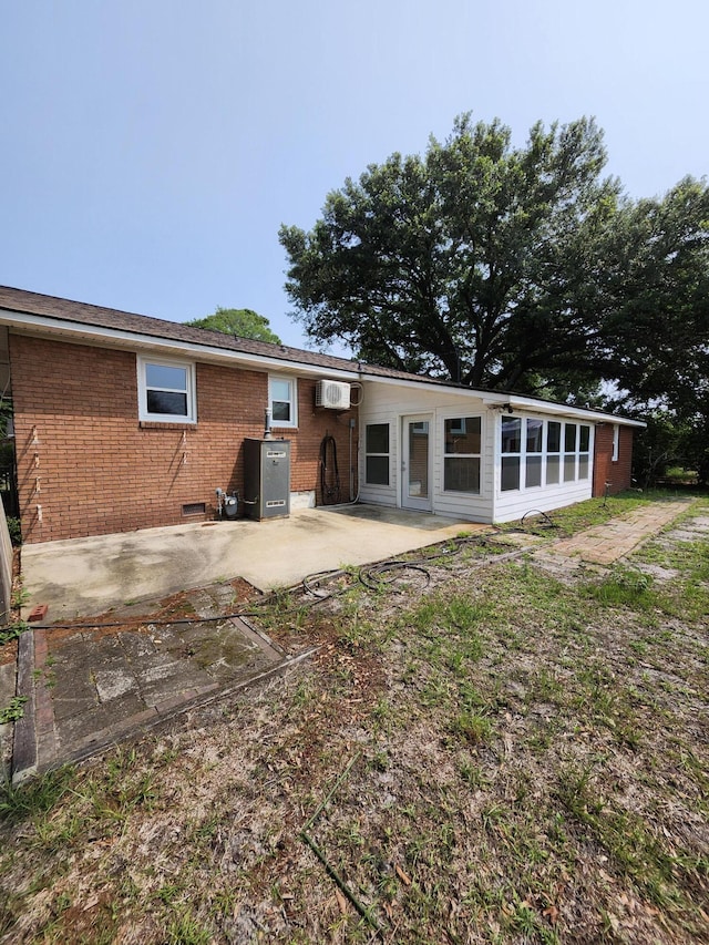 4029 Karen Dr, North Charleston, SC 29405 - rear view of house featuring a patio, brick siding, and a wall mounted air conditioner