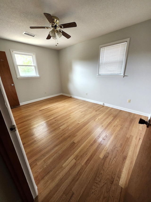 4029 Karen Dr, North Charleston, SC 29405 - unfurnished room featuring light wood-style flooring, ceiling fan, a textured ceiling, and baseboards