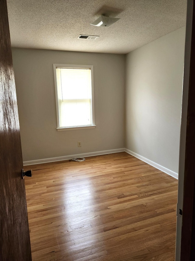 4029 Karen Dr, North Charleston, SC 29405 - empty room featuring a textured ceiling, wood finished floors, and baseboards