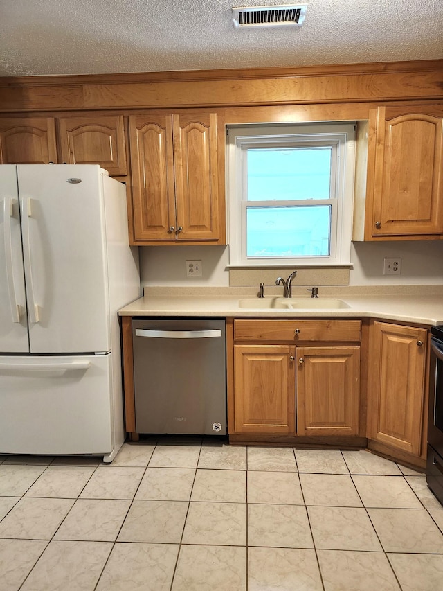 4029 Karen Dr, North Charleston, SC 29405 - kitchen with dishwasher, freestanding refrigerator, a sink, light countertops, and a textured ceiling