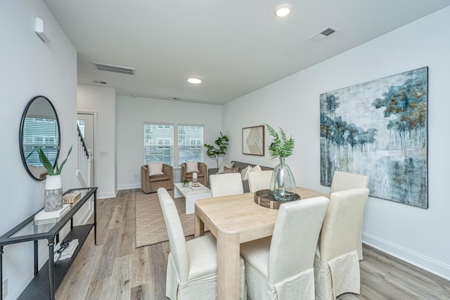 dining space with light wood-style flooring, visible vents, baseboards, and recessed lighting