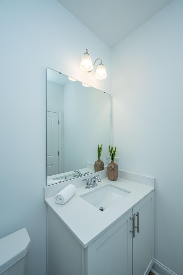 bathroom with toilet and vanity