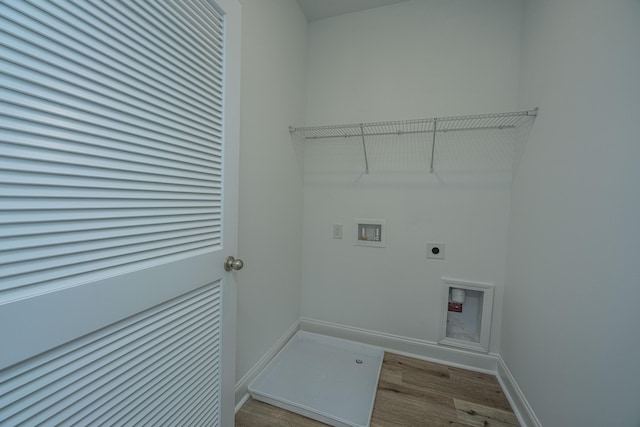 washroom featuring laundry area, baseboards, wood finished floors, hookup for a washing machine, and hookup for an electric dryer