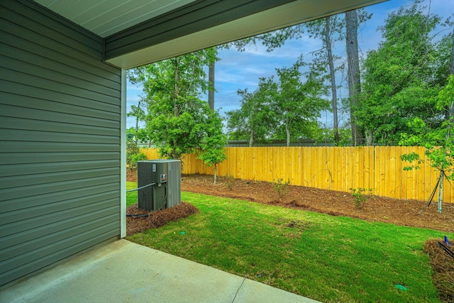 view of yard featuring central air condition unit and fence