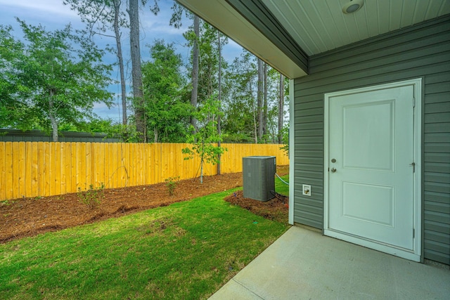 view of yard with cooling unit and fence