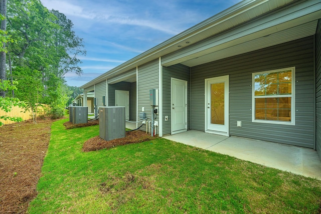 exterior space with a patio area, a yard, and central air condition unit