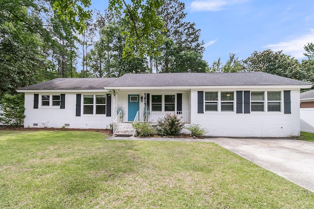 ranch-style home featuring covered porch, a front yard, roof with shingles, brick siding, and crawl space