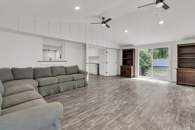 living room with recessed lighting, ceiling fan, wood finished floors, and vaulted ceiling