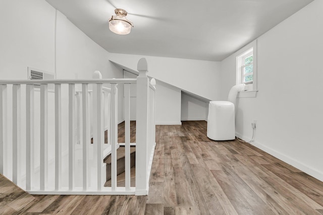interior space with visible vents, baseboards, and wood finished floors