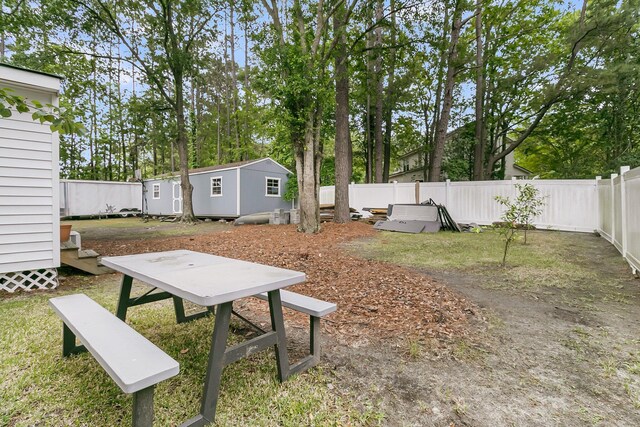 view of yard with a fenced backyard and an outdoor structure