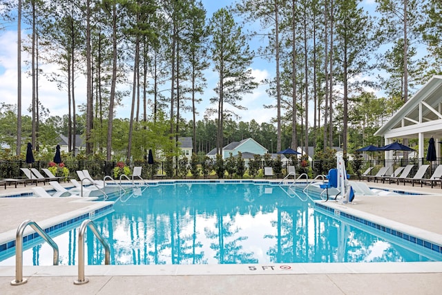 community pool featuring a patio area and fence