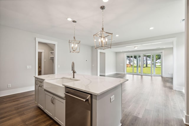 kitchen with light stone counters, recessed lighting, dark wood-style flooring, a sink, and dishwasher