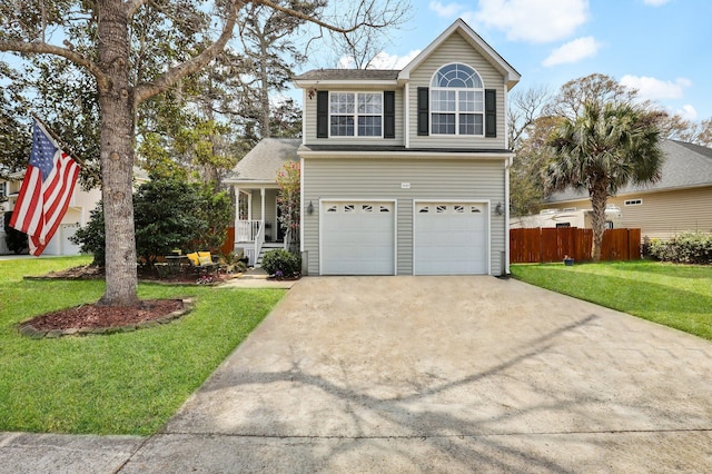 traditional-style house featuring a front lawn, fence, a porch, driveway, and an attached garage