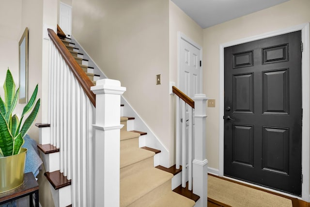 entryway with stairs and baseboards