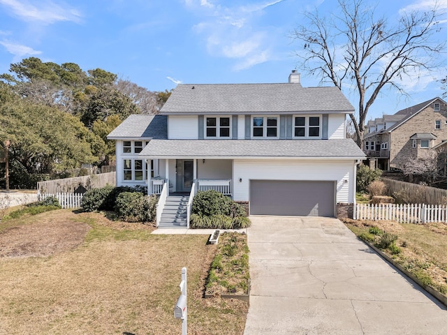 view of front facade with a front lawn, fence, a porch, and concrete driveway