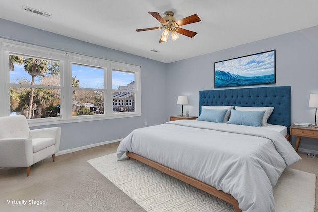 bedroom featuring light carpet, visible vents, and baseboards