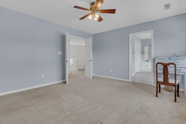 unfurnished room with light carpet, ceiling fan, visible vents, and baseboards