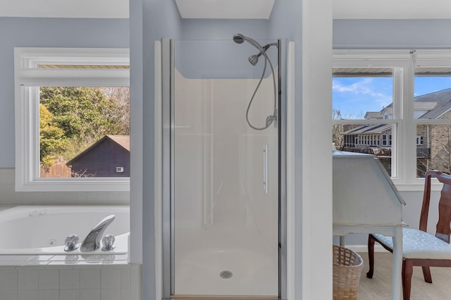 full bath featuring a stall shower, plenty of natural light, and a whirlpool tub