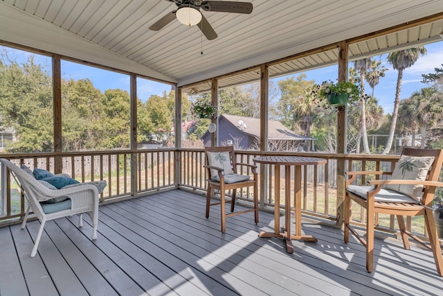 sunroom / solarium with lofted ceiling and ceiling fan