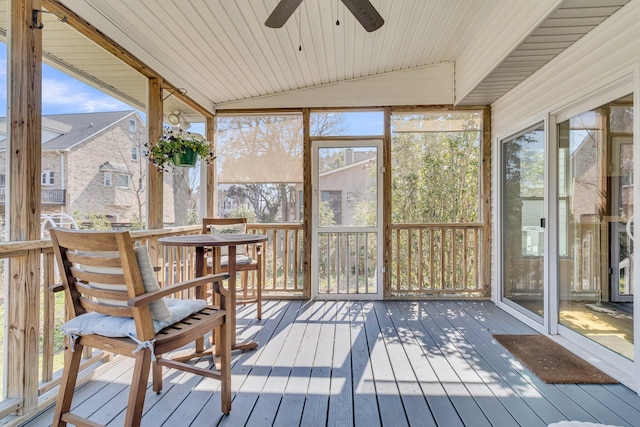 unfurnished sunroom featuring lofted ceiling, wood ceiling, and ceiling fan