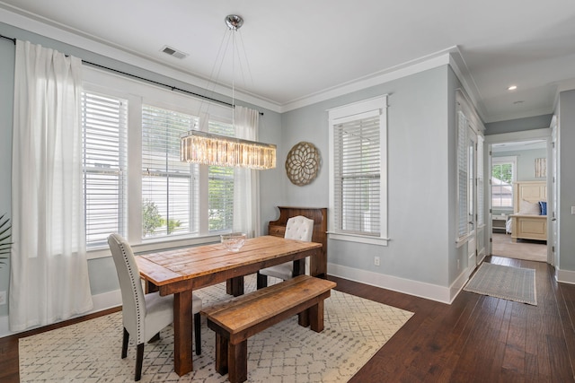 dining room featuring crown molding and dark hardwood / wood-style floors