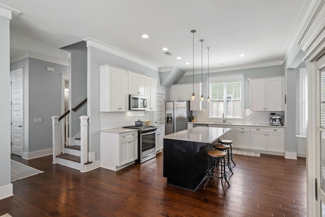 kitchen with white cabinetry, a center island, and appliances with stainless steel finishes