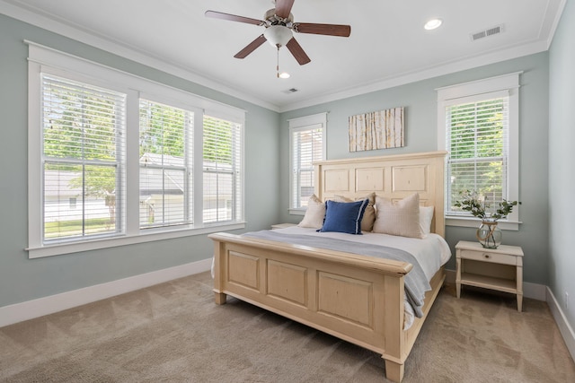 carpeted bedroom featuring ornamental molding and ceiling fan