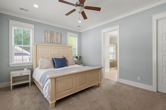 carpeted bedroom featuring multiple windows, crown molding, ceiling fan, and ensuite bath