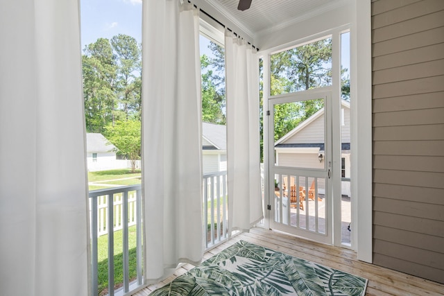 entryway featuring crown molding, plenty of natural light, and light hardwood / wood-style flooring