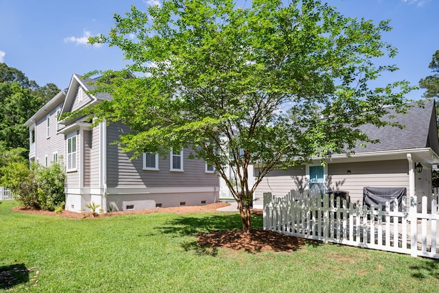 view of side of property with a yard