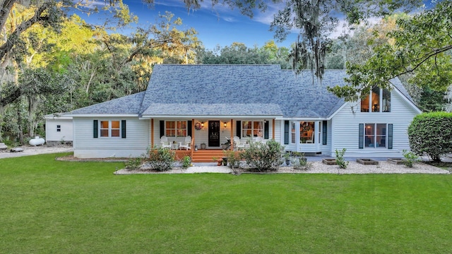 back of house with covered porch and a lawn