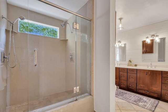 bathroom with tile patterned flooring, vanity, and a shower with shower door