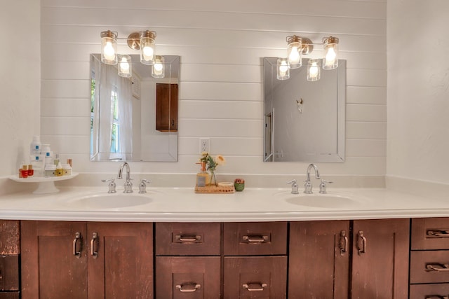 bathroom with vanity and wood walls