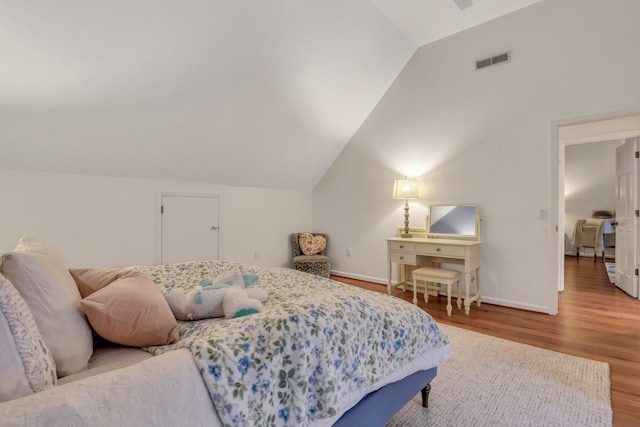 bedroom featuring hardwood / wood-style flooring and lofted ceiling