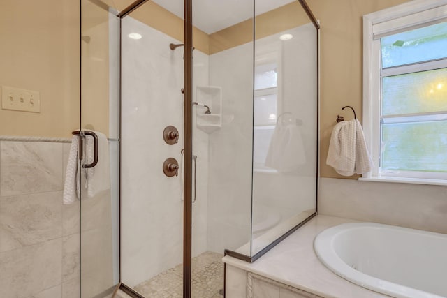 bathroom with separate shower and tub