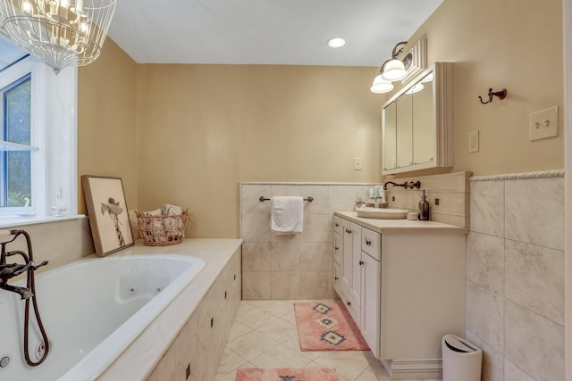 bathroom with vanity, tile walls, a notable chandelier, tile patterned flooring, and tiled bath