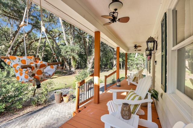 wooden terrace with covered porch and ceiling fan