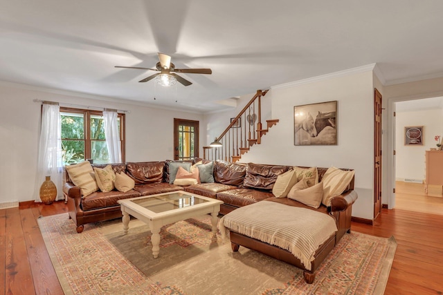 living room with ceiling fan, light wood-type flooring, and ornamental molding