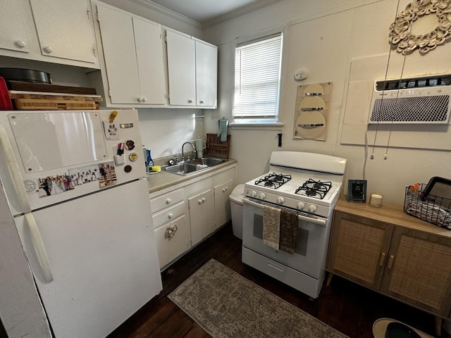 kitchen featuring white appliances, white cabinets, dark wood-type flooring, sink, and ornamental molding